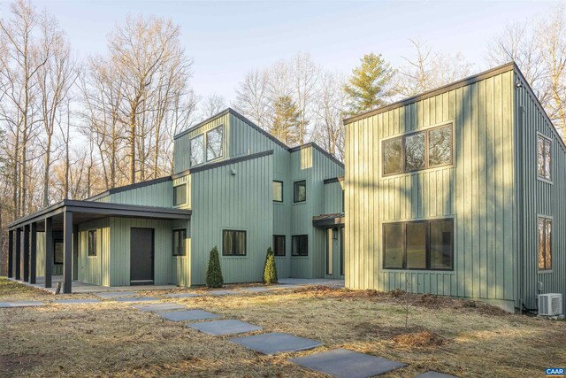 exterior space with central air condition unit and board and batten siding