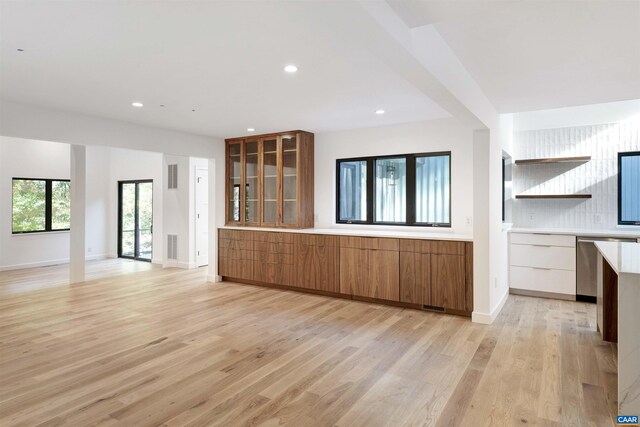 unfurnished living room with baseboards, light wood finished floors, recessed lighting, and visible vents