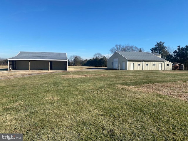  - view of grassy yard featuring an outbuilding