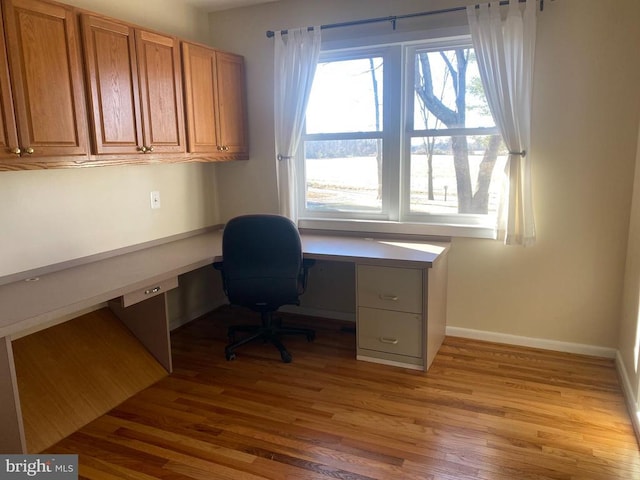  - office space featuring built in study area, light wood finished floors, and baseboards