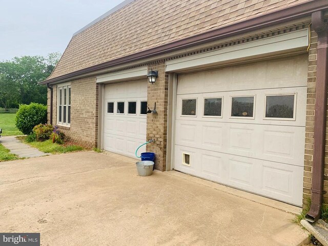  - garage featuring concrete driveway