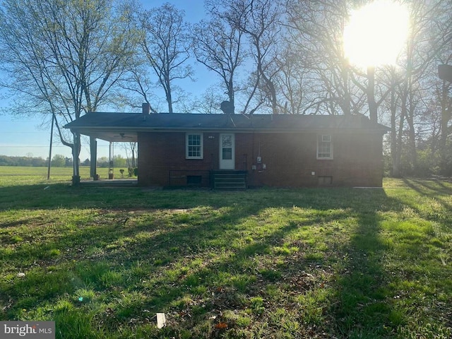  - view of front facade featuring a front lawn and a chimney