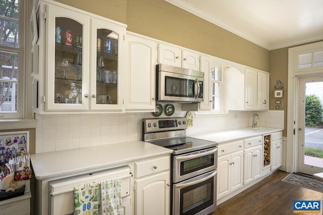 3809 Peakland Pl, Lynchburg, VA 24503 - kitchen with appliances with stainless steel finishes, dark wood-style floors, glass insert cabinets, light countertops, and backsplash