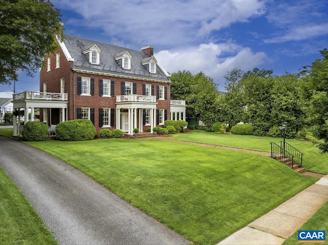 3809 Peakland Pl, Lynchburg, VA 24503 - colonial-style house featuring brick siding, a chimney, a balcony, a high end roof, and a front yard