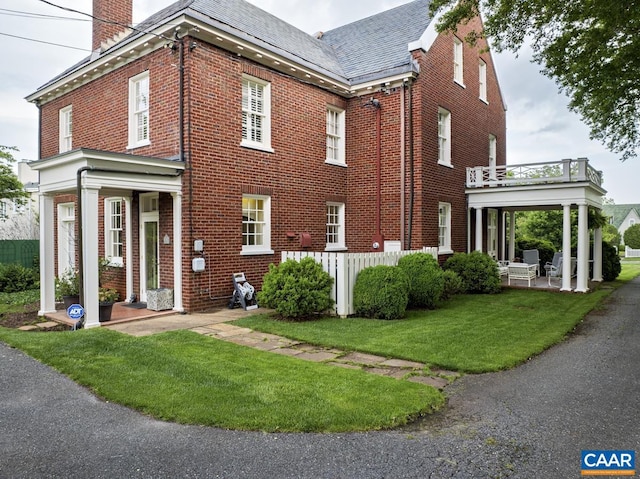 3809 Peakland Pl, Lynchburg, VA 24503 - view of front facade featuring brick siding, a chimney, a front lawn, and a patio