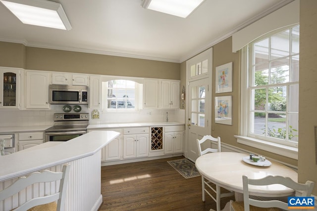 3809 Peakland Pl, Lynchburg, VA 24503 - kitchen with stainless steel appliances, backsplash, ornamental molding, dark wood-style flooring, and white cabinets