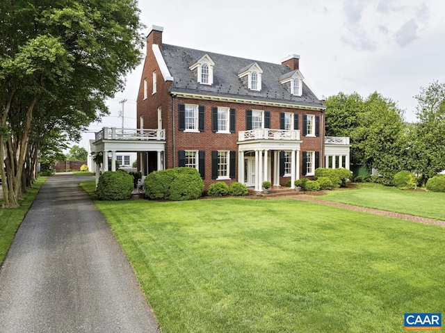 3809 Peakland Pl, Lynchburg, VA 24503 - colonial house featuring a high end roof, a balcony, brick siding, a chimney, and a front yard