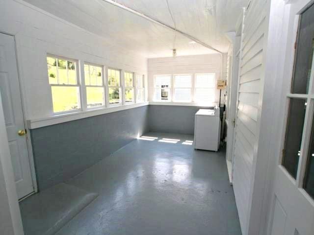 unfurnished sunroom featuring washer / clothes dryer