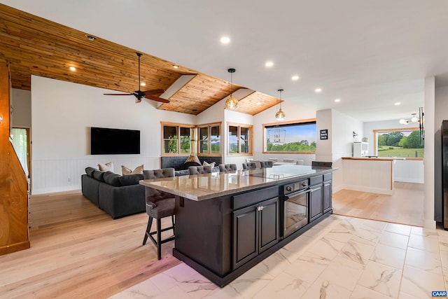 1900 Lowesville Rd, Amherst, VA 24521 - kitchen with light marble finish floors, a center island, black appliances, recessed lighting, and light stone countertops