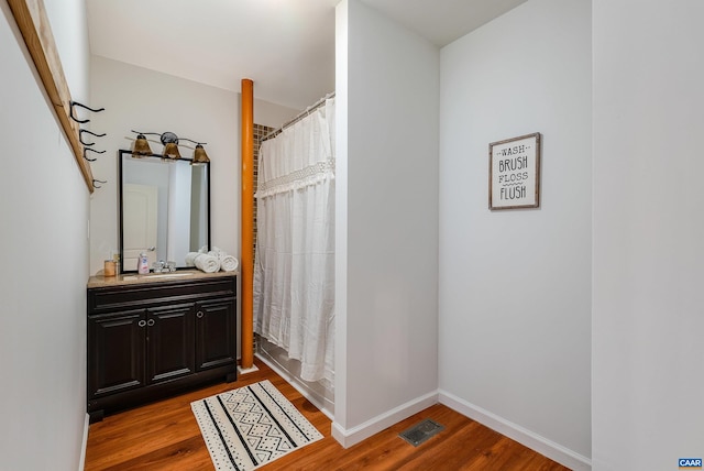 1900 Lowesville Rd, Amherst, VA 24521 - full bathroom with wood finished floors, vanity, baseboards, and shower / bath combination with curtain