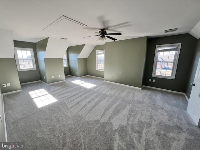 additional living space featuring carpet floors, a wealth of natural light, and visible vents