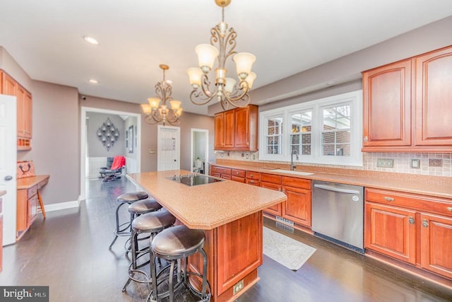 kitchen with dishwasher, a kitchen island, a notable chandelier, black electric cooktop, and a sink