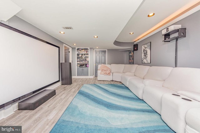 cinema room featuring built in features, light wood-type flooring, visible vents, and recessed lighting