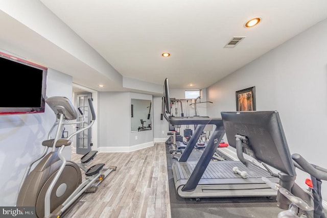 exercise room featuring recessed lighting, visible vents, baseboards, and wood finished floors