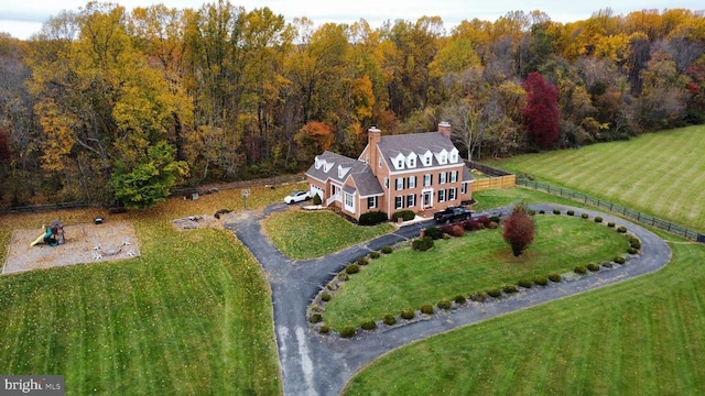 drone / aerial view with a wooded view