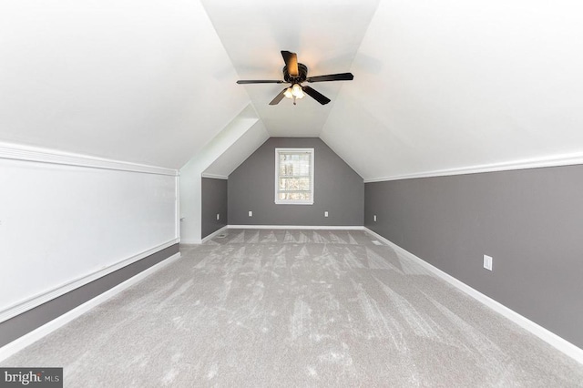 bonus room featuring lofted ceiling, carpet, ceiling fan, and baseboards