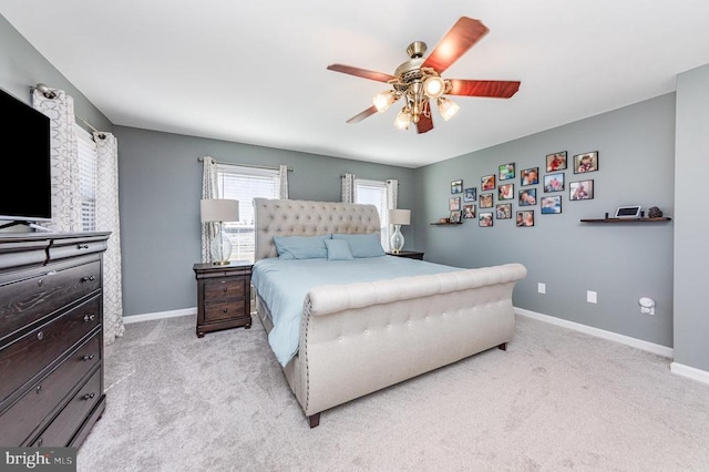 bedroom featuring light carpet, ceiling fan, and baseboards