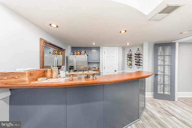 kitchen with visible vents, gray cabinets, light wood-style floors, stainless steel refrigerator with ice dispenser, and recessed lighting