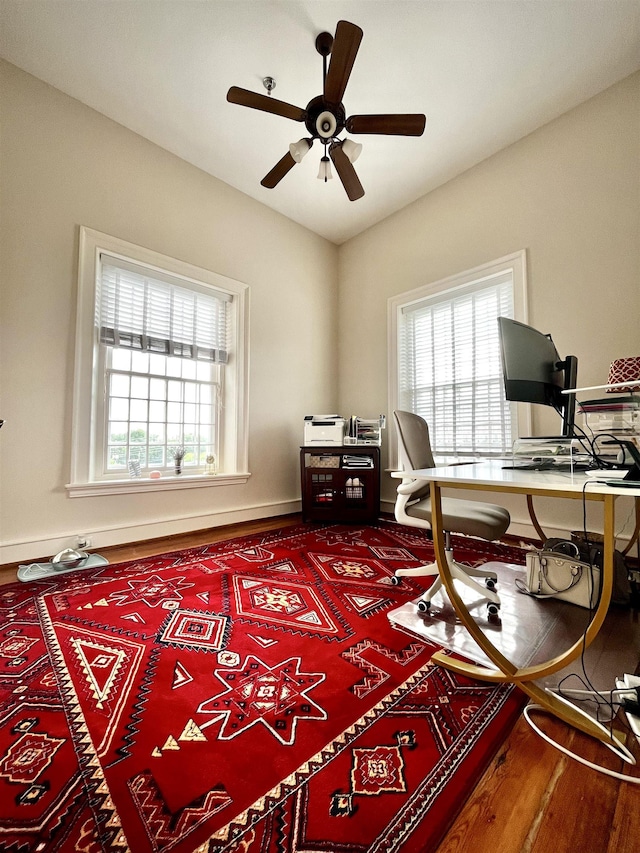 office space featuring baseboards and a ceiling fan