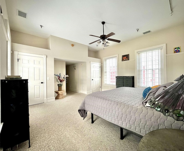 bedroom featuring baseboards, ceiling fan, visible vents, and carpet