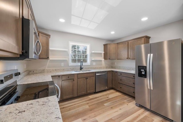 1024 D St, Waynesboro, VA 22980 - kitchen featuring appliances with stainless steel finishes, open shelves, light wood finished floors, light stone counters, and recessed lighting