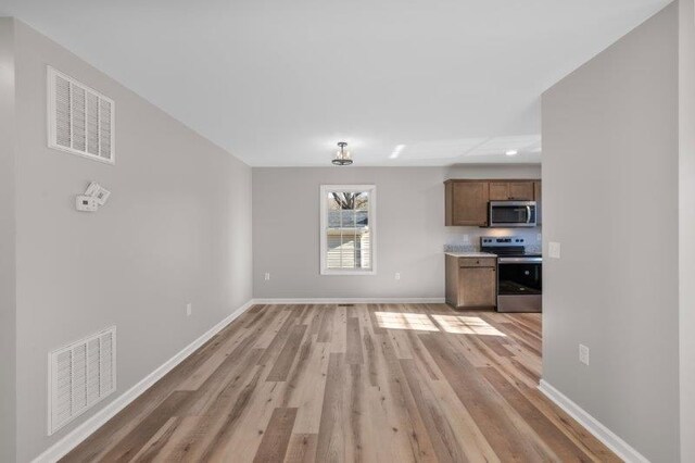 1024 D St, Waynesboro, VA 22980 - unfurnished living room with light wood-style flooring and recessed lighting