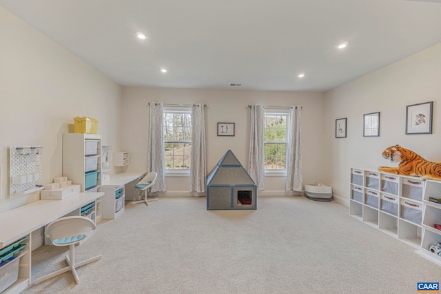 playroom with recessed lighting, healthy amount of natural light, light carpet, a desk, and baseboards