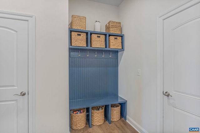mudroom featuring wood finished floors and baseboards