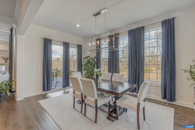 dining space featuring plenty of natural light, baseboards, wood finished floors, a chandelier, and recessed lighting