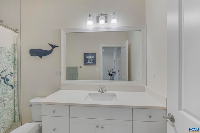 full bathroom featuring toilet, vanity, and curtained shower