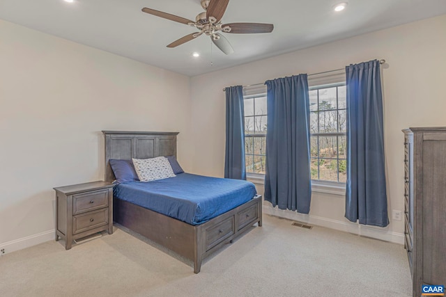 bedroom with light colored carpet, baseboards, recessed lighting, and a ceiling fan