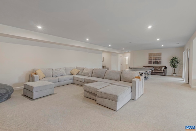 carpeted living area with recessed lighting and baseboards