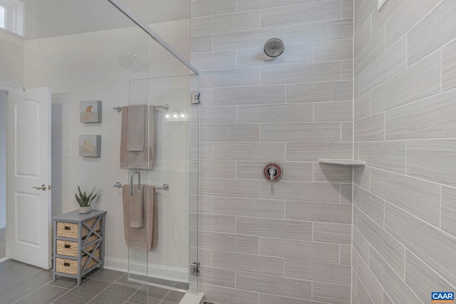 bathroom featuring a stall shower, tile patterned floors, and baseboards