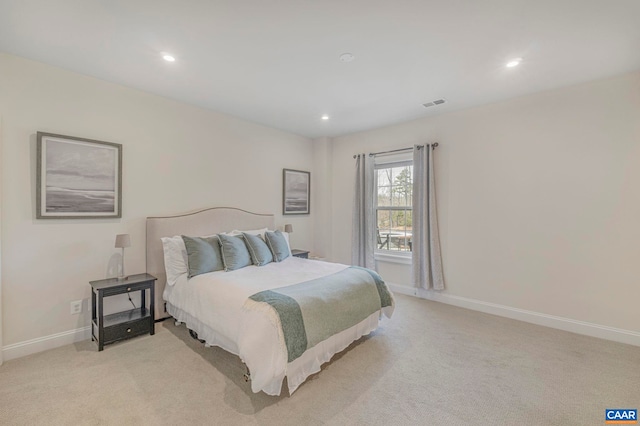bedroom featuring light carpet, recessed lighting, and baseboards