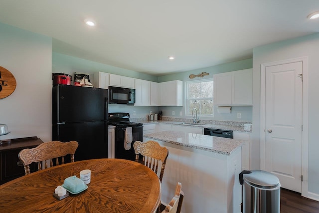 1113 Scruggs Ln, Grottoes, VA 24441 - kitchen with a sink, black appliances, recessed lighting, white cabinets, and light stone countertops