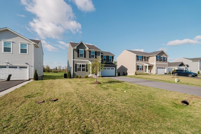1113 Scruggs Ln, Grottoes, VA 24441 - traditional-style home with a front yard, a residential view, aphalt driveway, and an attached garage