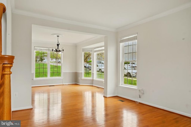607 Woodruff Ln, Culpeper, VA 22701 - unfurnished room with a chandelier, wood finished floors, healthy amount of natural light, and crown molding