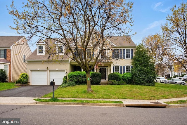 607 Woodruff Ln, Culpeper, VA 22701 - colonial house with stucco siding, asphalt driveway, a front lawn, and an attached garage