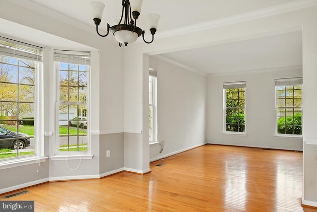 607 Woodruff Ln, Culpeper, VA 22701 - empty room with healthy amount of natural light, wood finished floors, a chandelier, and ornamental molding