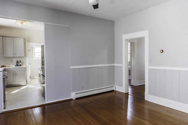 120 Jefferson St S, Lexington, VA 24450 - unfurnished room featuring a baseboard radiator, hardwood / wood-style flooring, wainscoting, a ceiling fan, and baseboard heating