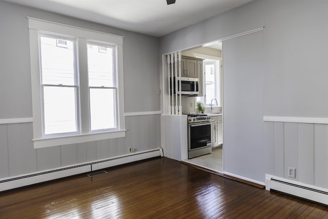 120 Jefferson St S, Lexington, VA 24450 - spare room with a baseboard heating unit, wainscoting, healthy amount of natural light, and hardwood / wood-style flooring