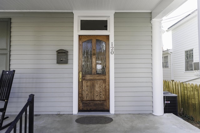 120 Jefferson St S, Lexington, VA 24450 - view of exterior entry featuring central AC unit, covered porch, and fence