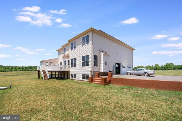 11425 Custers Trce, Spotsylvania, VA 22553 - back of property with stairs, a garage, driveway, a lawn, and a deck