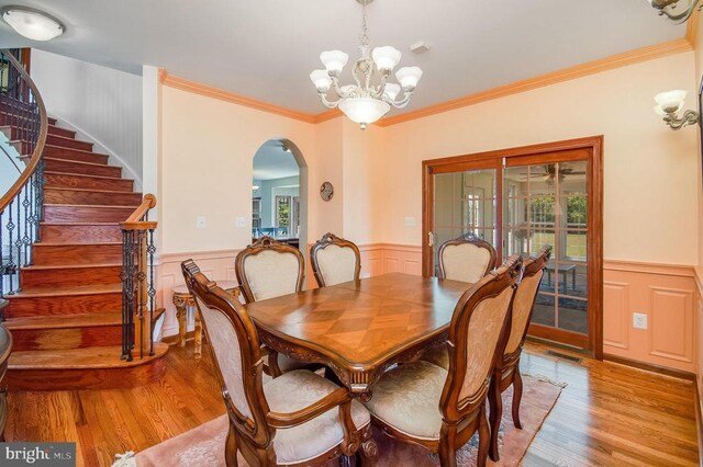 11425 Custers Trce, Spotsylvania, VA 22553 - dining space featuring light wood-style floors, arched walkways, wainscoting, a chandelier, and ornamental molding