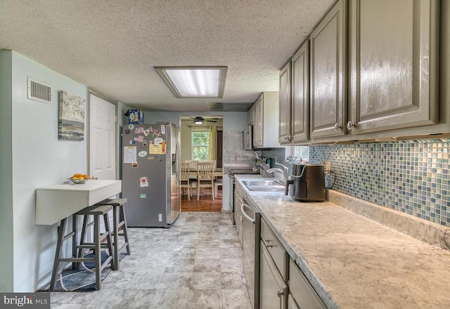 5575 Jeffersonton Rd, Jeffersonton, VA 22724 - kitchen with appliances with stainless steel finishes, decorative backsplash, light countertops, a textured ceiling, and a ceiling fan