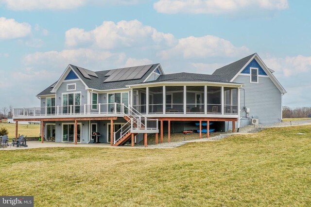 310 Elk Creek Lndg, Mineral, VA 23117 - rear view of property featuring a sunroom, a patio area, solar panels, stairs, and a wooden deck