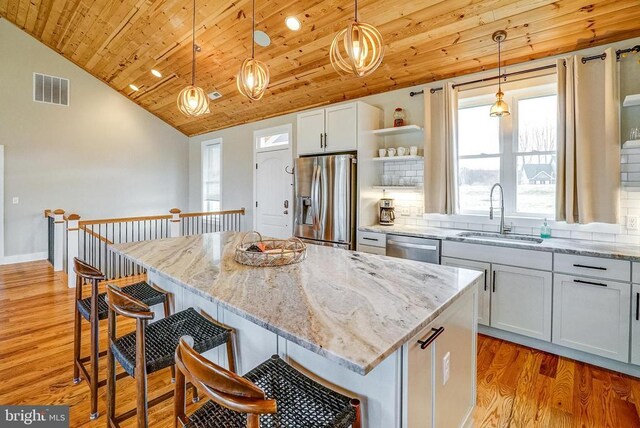 310 Elk Creek Lndg, Mineral, VA 23117 - kitchen featuring stainless steel appliances, a sink, open shelves, wooden ceiling, and light stone counters
