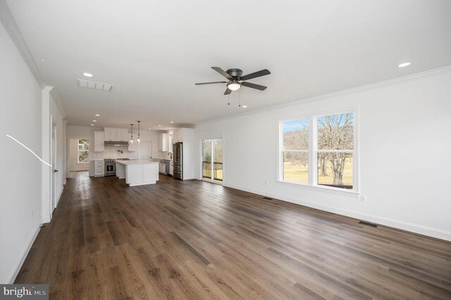  - unfurnished living room with crown molding, a ceiling fan, baseboards, healthy amount of natural light, and recessed lighting