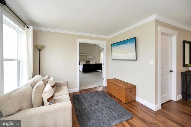  - living area with wood finished floors, baseboards, and crown molding