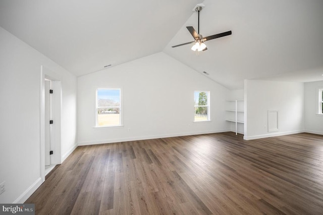  - unfurnished living room featuring ceiling fan, vaulted ceiling, dark wood-type flooring, and baseboards